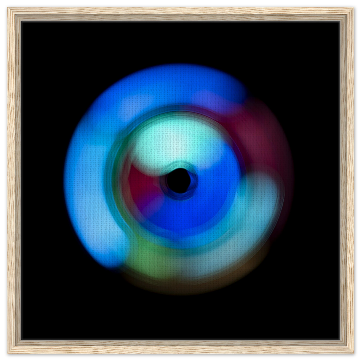 A circular radial pattern with electric blue outer regions, magenta middle zones, and pale green accents surrounding a small dark center circle.