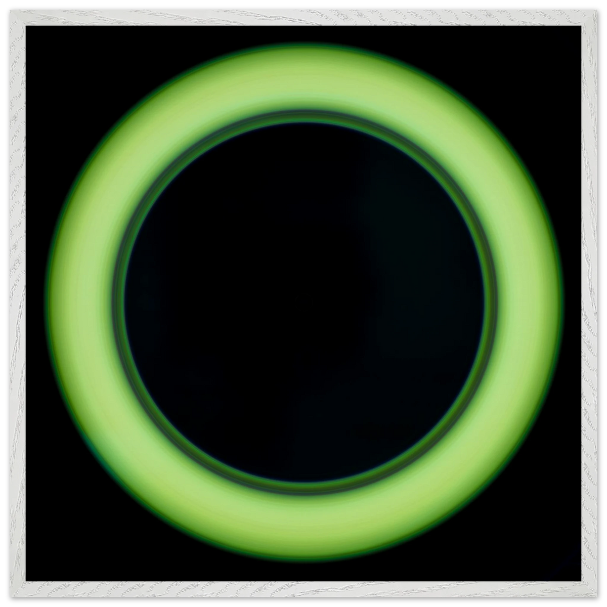 A bright lime green circular ring shape with a large black center and soft glowing edges against a black background.
