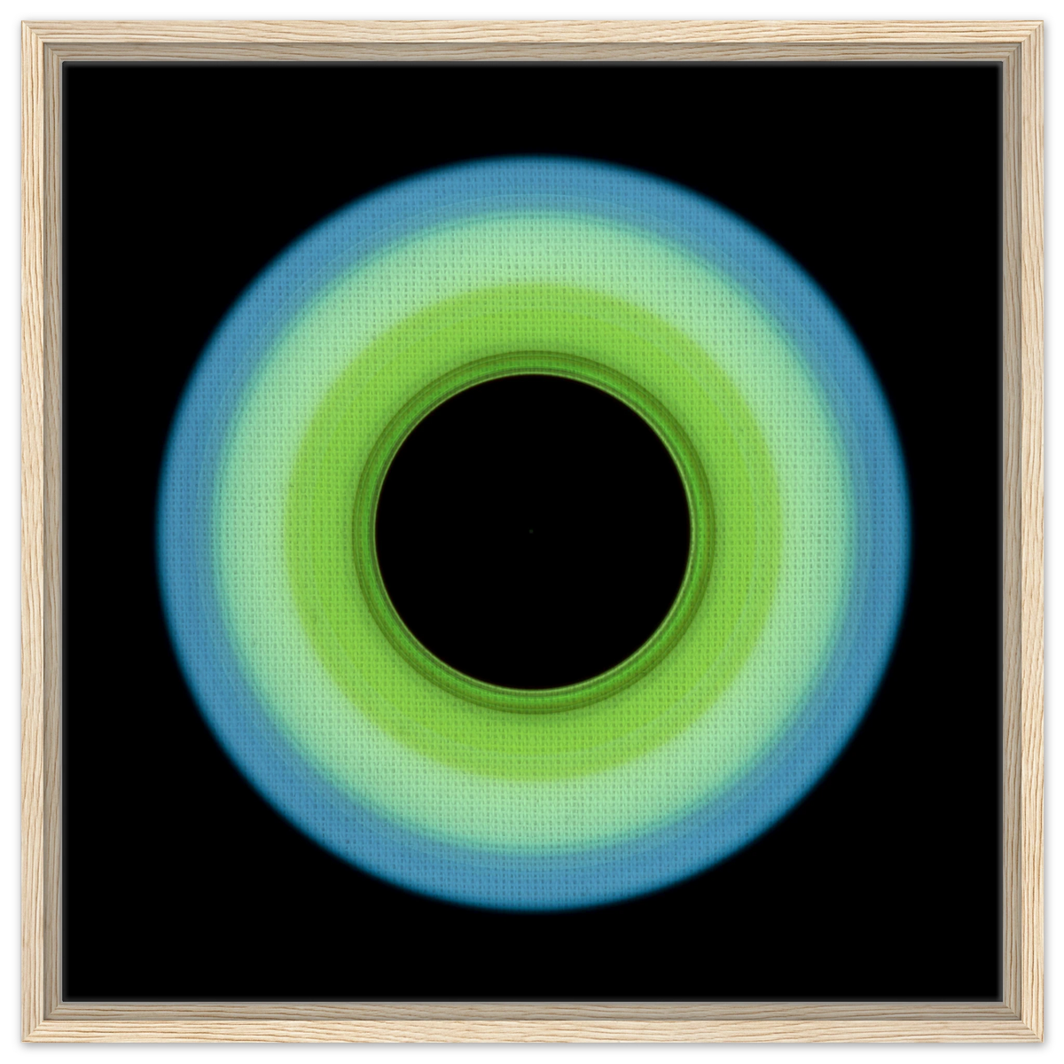 A circular ring shape that transitions from pale blue on the outer edge to bright lime green on the inner edge with a large black circular center.