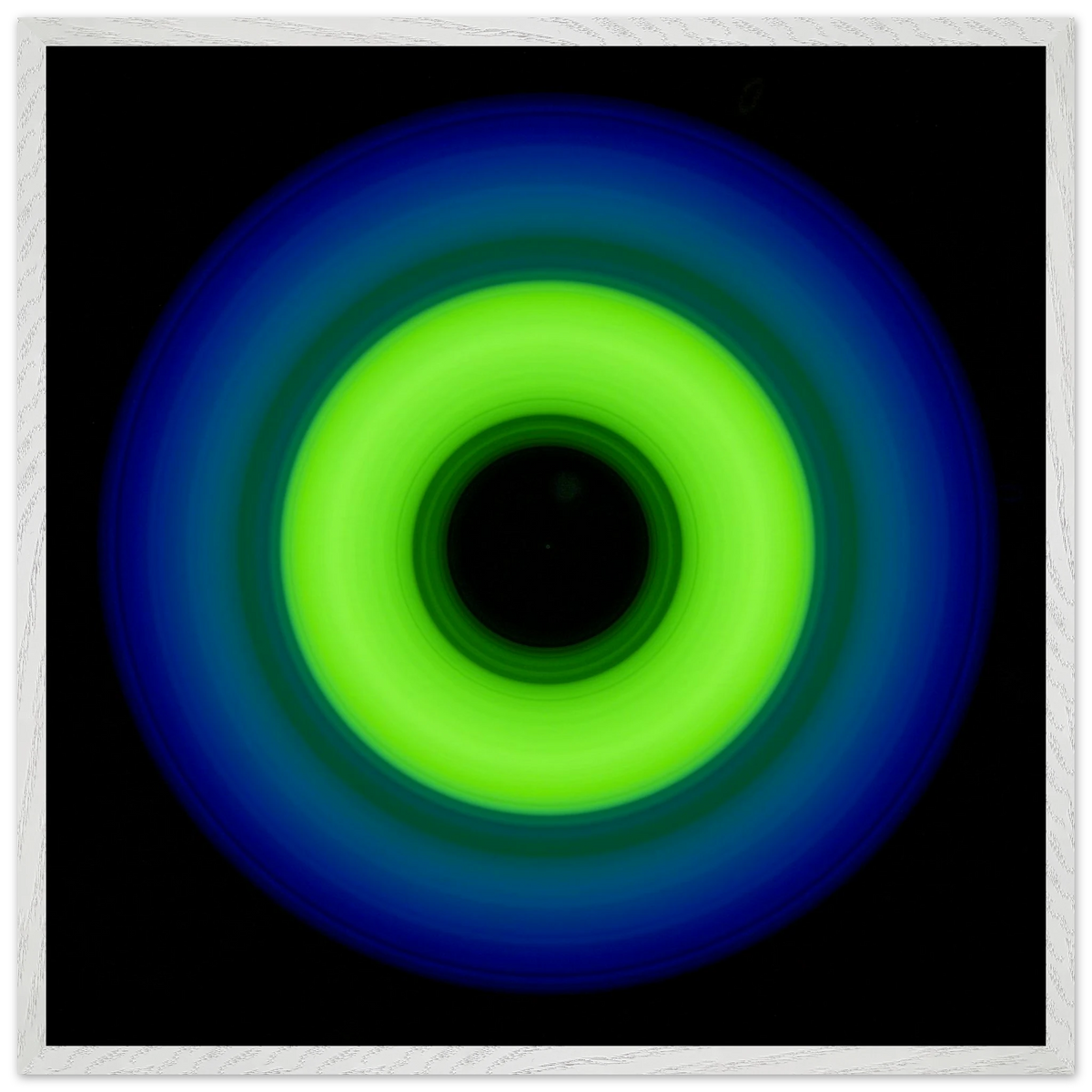 A circular ring shape with bright lime green center transitioning through teal to cobalt blue outer edge with black center void.