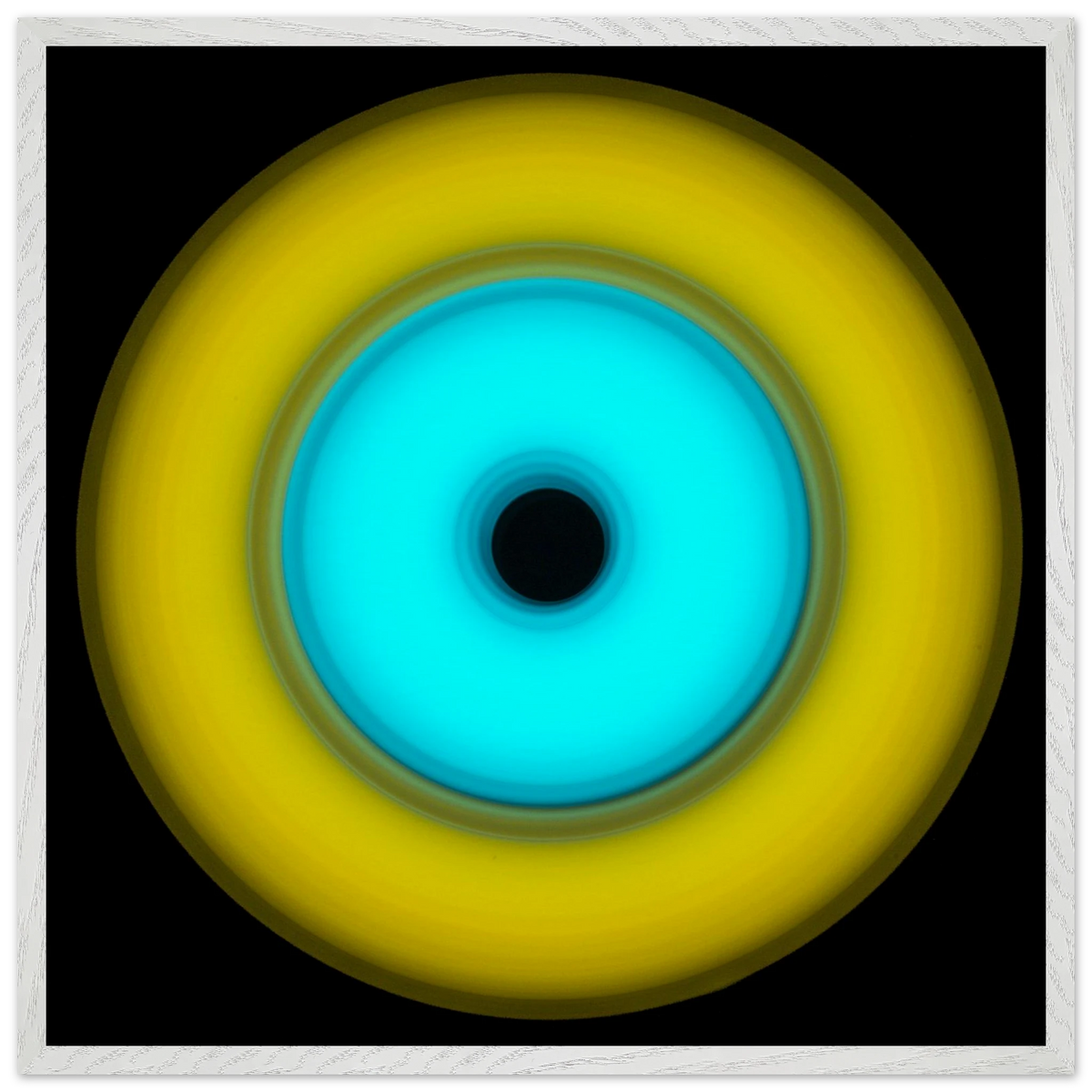 A circular aperture shape with bright yellow outer ring, electric cyan inner circle, and small black center hole against a black background.
