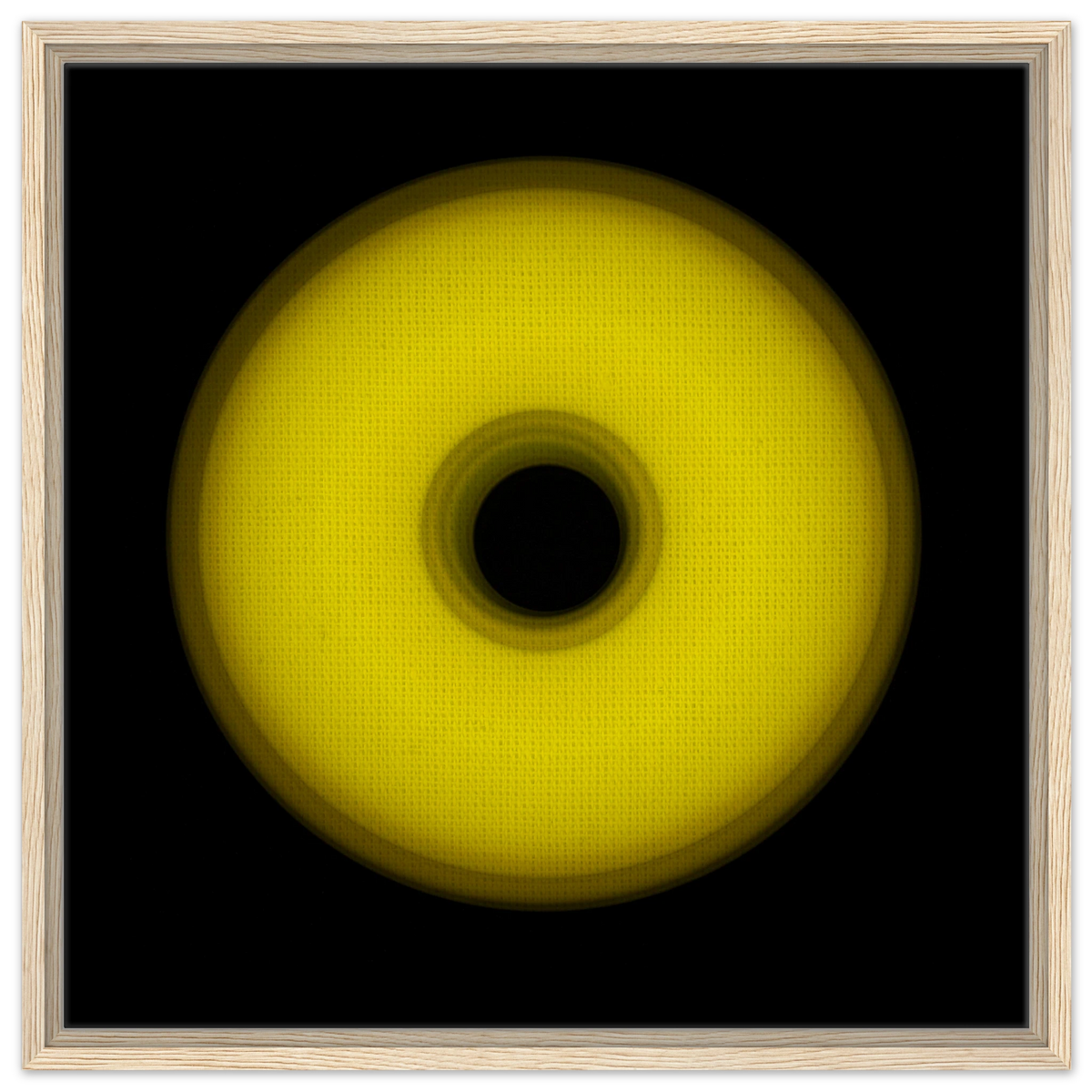 A circular yellow ring that gradients from bright yellow at the edges to olive green toward the dark center hole.