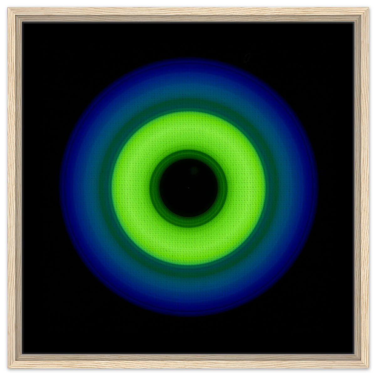 A circular ring shape with bright lime green center transitioning through teal to cobalt blue outer edge with black center void.