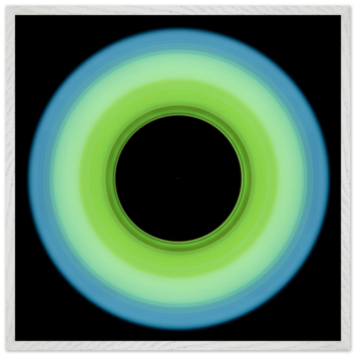 A circular ring shape that transitions from pale blue on the outer edge to bright lime green on the inner edge with a large black circular center.