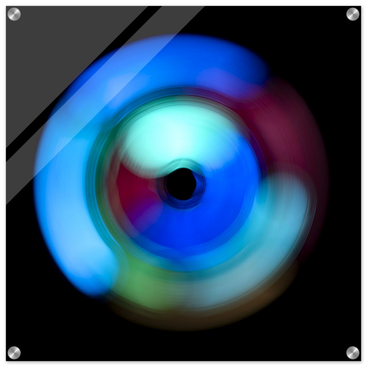A circular radial pattern with electric blue outer regions, magenta middle zones, and pale green accents surrounding a small dark center circle.